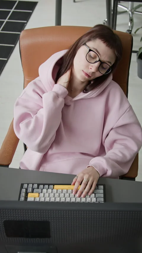 Young Female Developer Massaging Neck while Working on Project on Computer Stock Footage 335940611