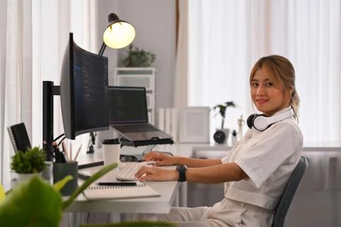 Young female developer working with coded data on computer screen. Developing Stockfoto's