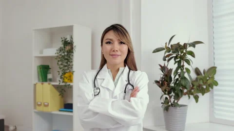 Young female doctor posing for camera and standing in clinic office during Stock Footage 162724232