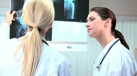 Young Female Doctors Looking at X-Rays Stock Footage