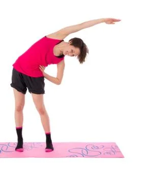 Young female doing exercise on the mat Stock Photos