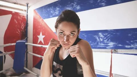 Young female doing shadow boxing exercise in a boxing ring. . Stock Photos