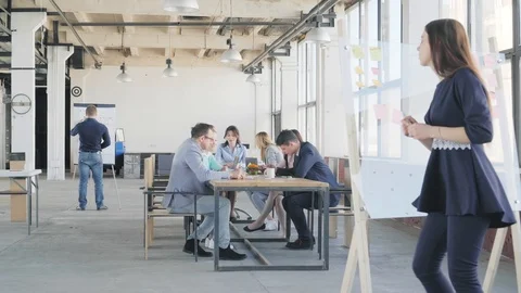 A young female employee finished preparing for the presentation on a glass board Stock Footage 109500976