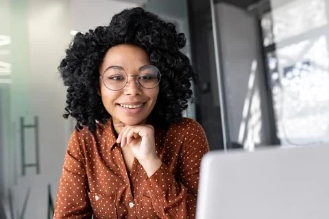 Young female employee programmer working at workplace inside office with laptop Stock-Fotos