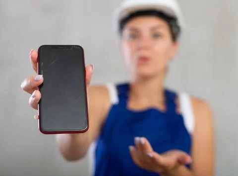 Young female engineer, architect in construction overalls and safety helmet Stockfoto's