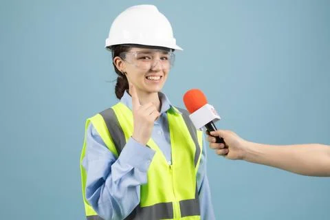 Young Female Engineer in Hard Hat Giving Media Interview Stock Photos