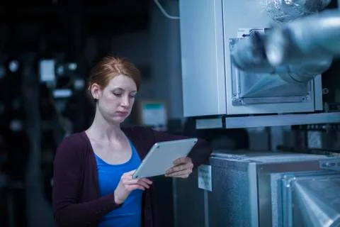 Young female engineer using a digital tablet in an industrial plant Stock Photos