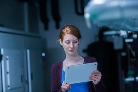 Young female engineer using a digital tablet in an industrial plant Stock Photos