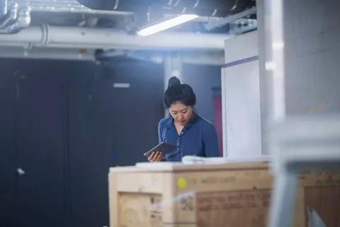 Young female engineer using digital tablet in an industrial plant Stock Photos