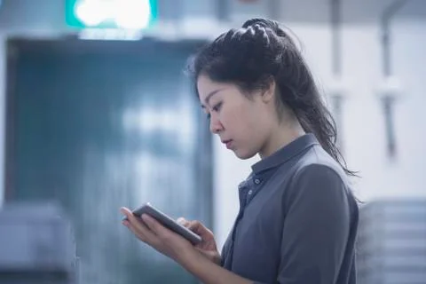 Young female engineer using digital tablet in an industrial plant Stock Photos