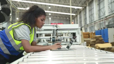 Young female engineers using laptop to check the operation Stock Footage 252912564
