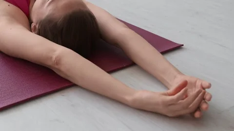 Young female exercising on mat, practising meditation on sunny day at home Stock Footage 247841006