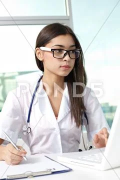 Young female general practitioner at work Stock Photos