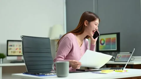 Young female graphic designer using digital tablet and laptop in modern off.. Video stock 312849280