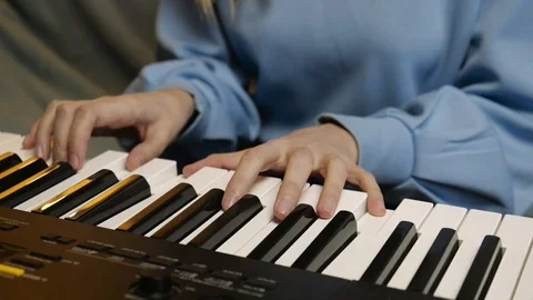 Young female hands learning playing electric piano. Woman fingers on keys. Stock Footage 129323553