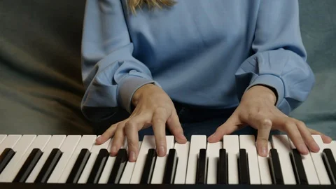 Young female hands learning playing electric piano. Woman fingers on keys. Stock Footage 129323661