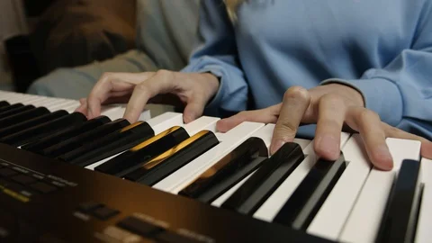 Young female hands learning playing electric piano. Woman fingers on keys. Stock Footage 129325577