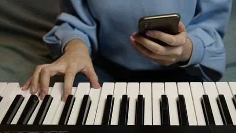 Young female hands learning playing electric piano. Woman fingers on keys. Stock Footage 129325719