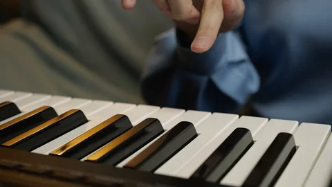 Young female hands learning playing electric piano. Woman fingers on keys. Stock Footage 129325754