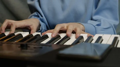 Young female hands learning playing electric piano. Woman fingers on keys. Stock Footage 129325827