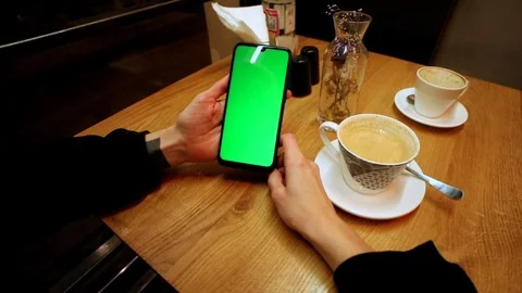 Young female hands using green screen smartphone resting in cafe drinking coffee 스톡 동영상 121741543
