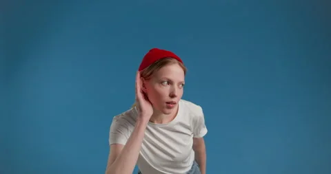 Young female with hearing problems holding hand near his ear and listening Video stock 150402125