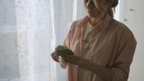 Young Female Inserts Her Hearing Aid In Her Ear Stock Footage 85569007