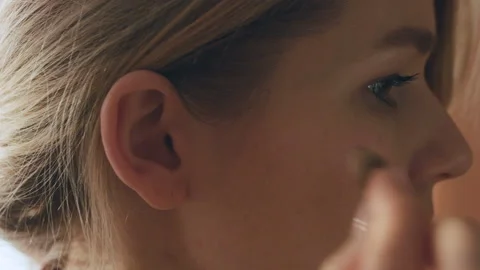 Young Female Inserts Her Right Hearing Aid In Her Ear Stock Footage 85566009