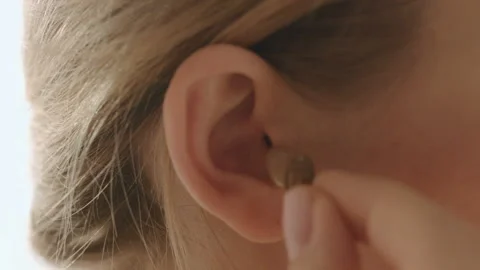 Young Female Inserts Her Right Hearing Aid In Her Ear Stock Footage 85566481