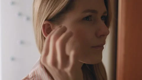 Young Female Inserts Her Right Hearing Aid In Her Ear Stock Footage 85568995