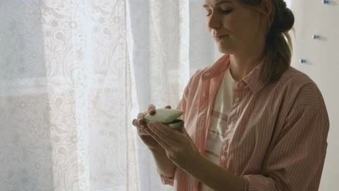 Young Female Inserts Her Right Hearing Aid In Her Ear Stock Footage 85569682