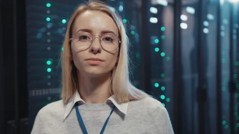 Young female IT administrator working at operational rack server room. Portrait Stock-Footage 119083796