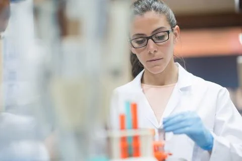 Young female lab technician analyzing blood samples in a clinical medical 스톡 사진