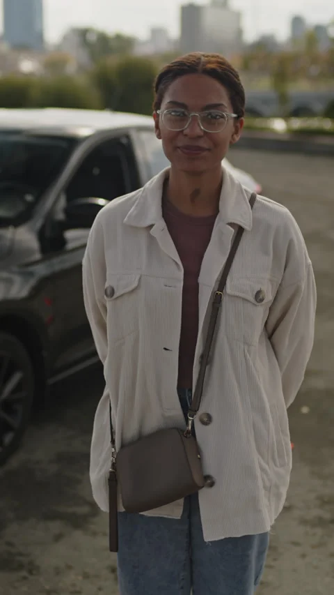 Young Female Learner of Driving School Posing Outside near Black Car Stock Footage 276539075