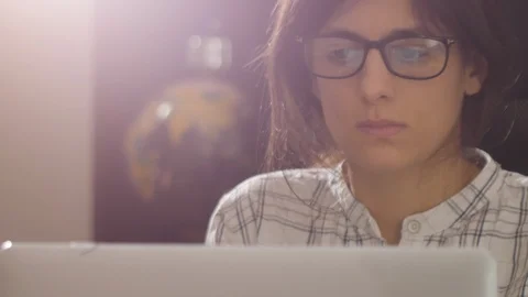 Young female looking into the computer screen. Stock Footage 102757406