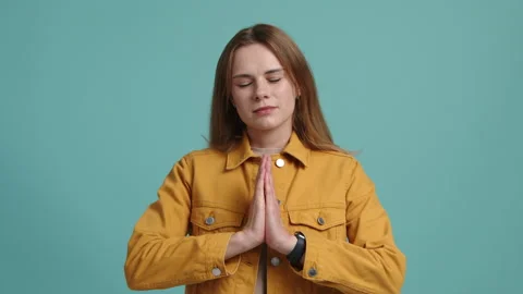 Young female looking focused while praying Stock Footage 236768067
