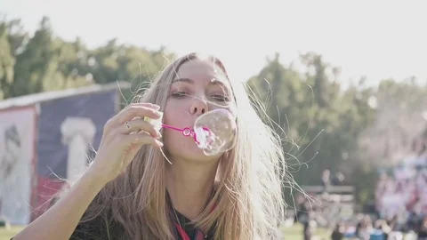 Young female makes soap bubbles Stock Footage 77278601