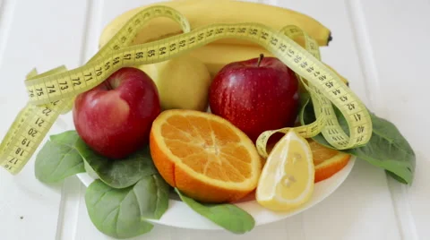 Young female making choice between cake and fruits Video stock 62827986