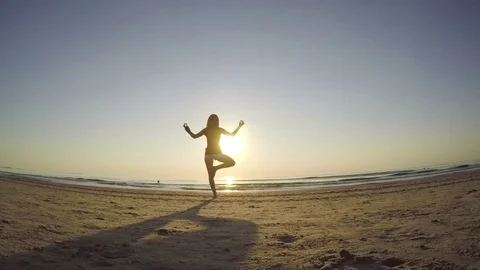 Young female making exercises on the beach Stock Footage 71998359