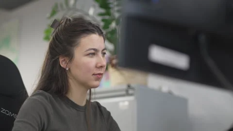 Young female manager works on computer in company office Stock Footage 325996734