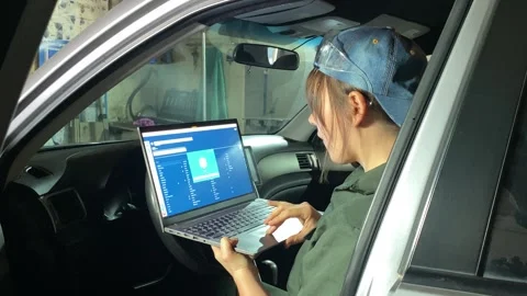 Young Female Mechanic Performs Computer Car Diagnostics Stock Footage 255738254