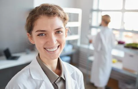 Young Female Medic Smiling in Laboratory Stock Photos