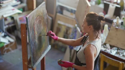 Young female painter creating artwork Stock Footage 142667448