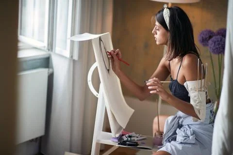 Young female painter in ecstasy while painting Stock Photos