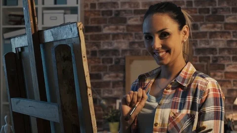 Young female painter working in the atelier Stock Footage 90386550