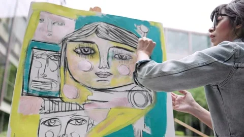 Young female painter working on canvas art painting outdoor Stock Footage 200912930