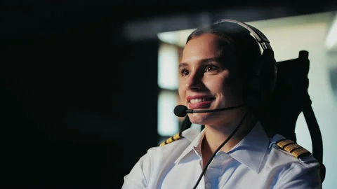 Young, female pilot sitting in cabin of aircraft, smiling. Stock Footage 234397199