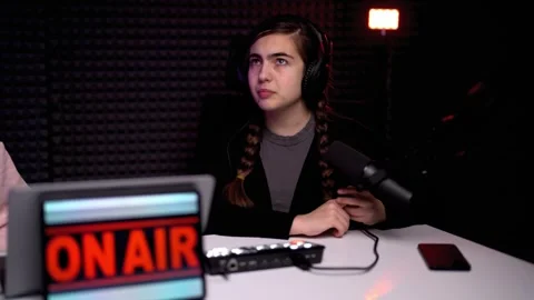 Young female podcaster interviewing guest in modern studio Stock Footage 246729856