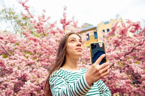 Young female posing for smartphone selfie portrait. Looking up Caucasian woman Stock Photos