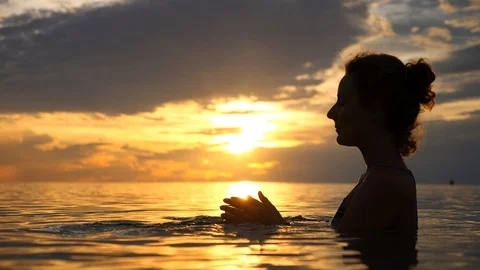 Young Female Praying And Practicing Yoga And Meditation At Sunset In The Sea Video stock 99876104